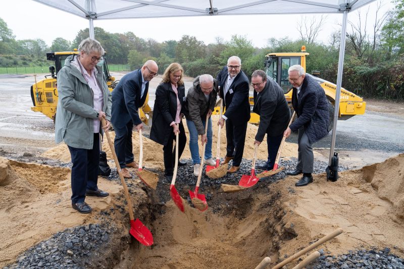 Die Zeitkapsel wird auf dem Baufeld in die Erde gelassen. Von links nach rechts: Annegret Bruchhausen-Scholich (Bürgermeisterin Leverkusen), Dirk Gengnagel (Wupperverband), Claudia Fischer (frühere Verbandsratsvorsitzende Wupperverband), Mike Giera (stv.